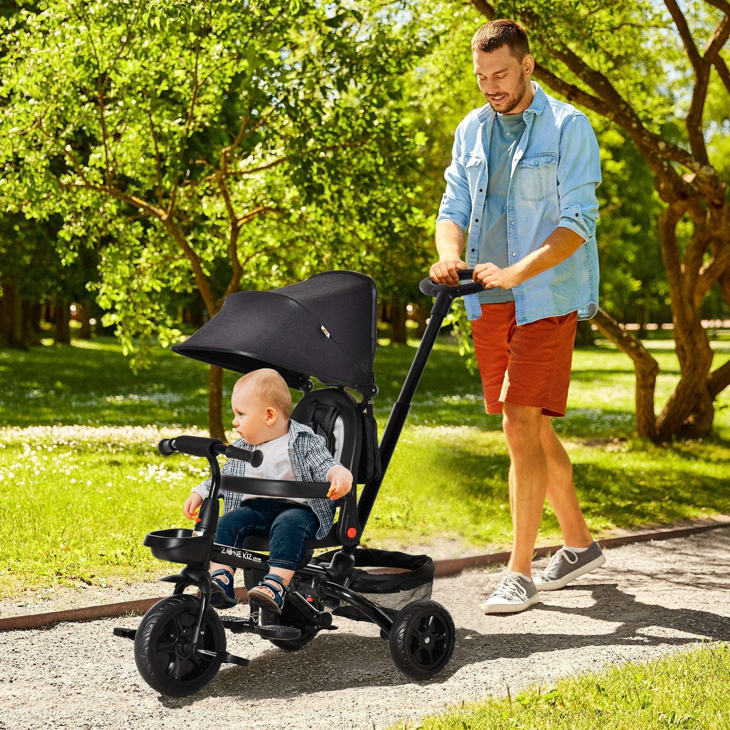 Kids 3-wheel tricycle stroller with black canopy and toddler seated front view, three wheels.