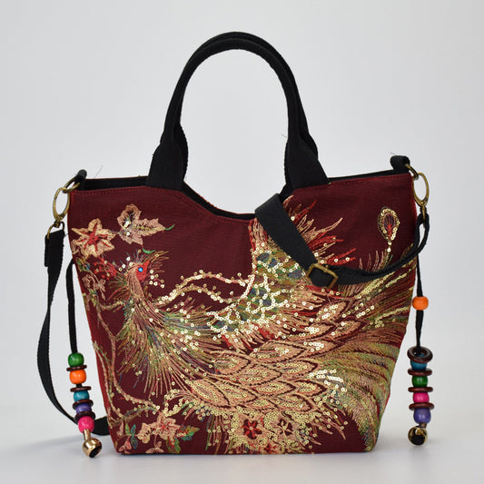 Decorative handbag with embroidered design on a plain background