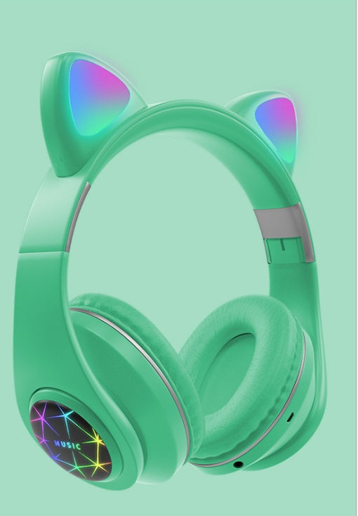 Green headphones with cat ear design and colorful lights on a light green background
