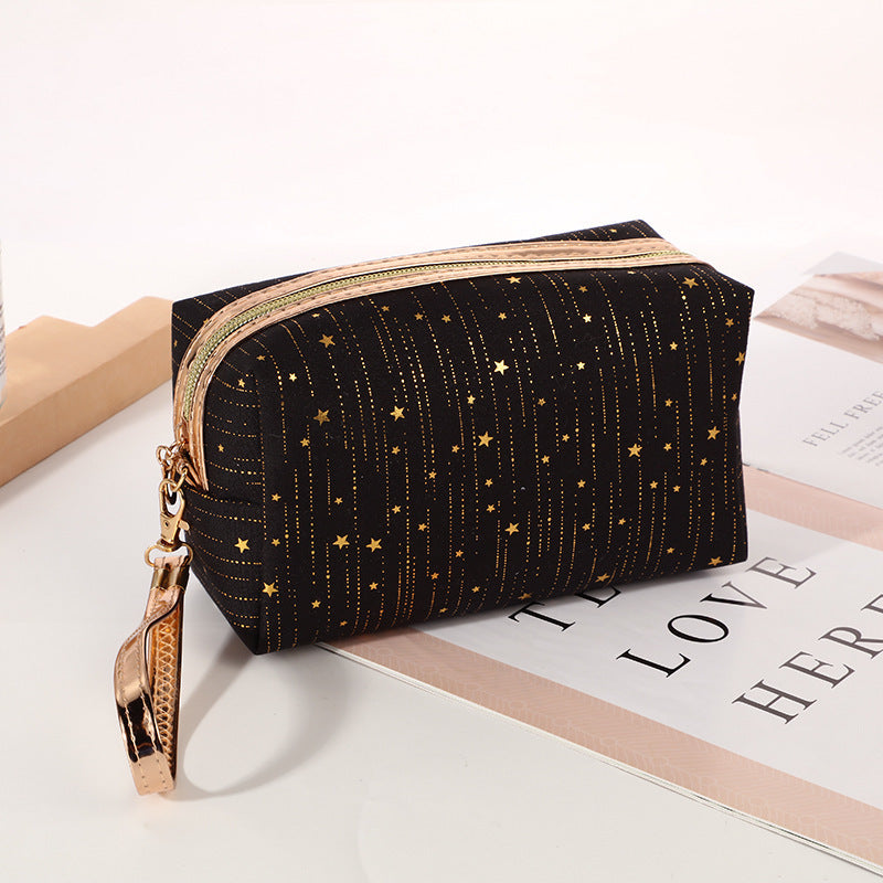 Black octagonal star cosmetic bag with gold zipper and wrist strap