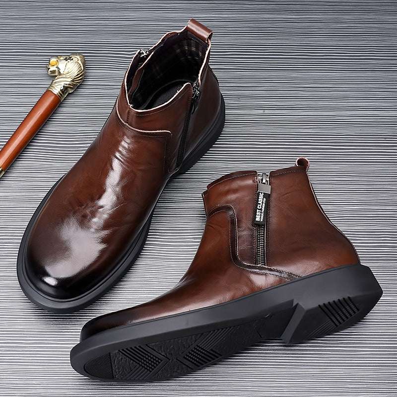 Pair of brown leather boots on a textured gray background