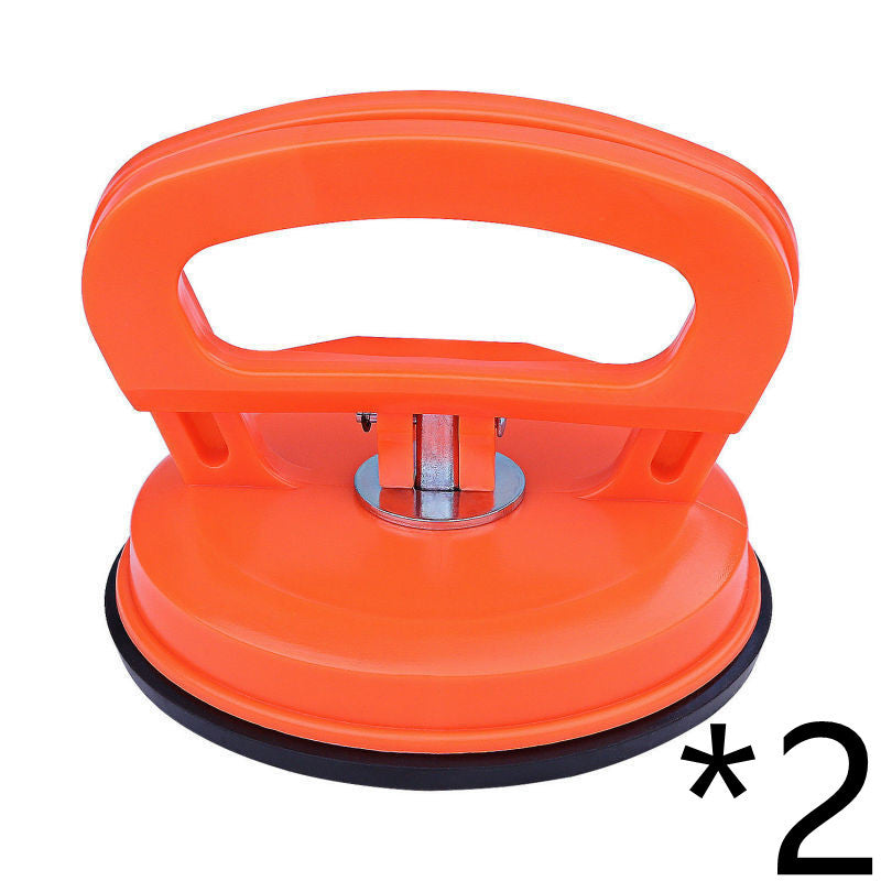Orange suction cup tool with black suction pad on a white background