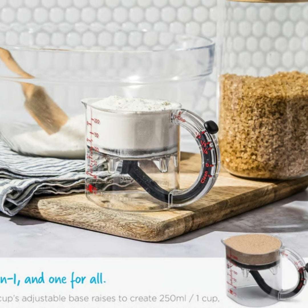 Clear measuring cup with adjustable base on a kitchen counter
