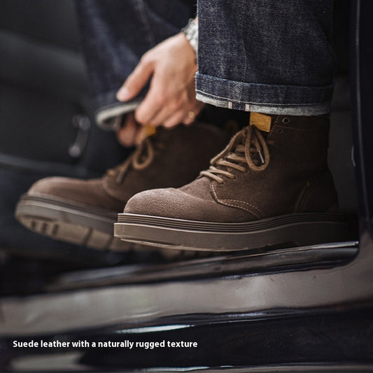 Brown suede boots with a rugged texture worn by a person sitting on a car.