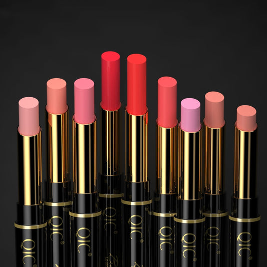 Set of lipsticks with gold caps and black bodies on a dark background