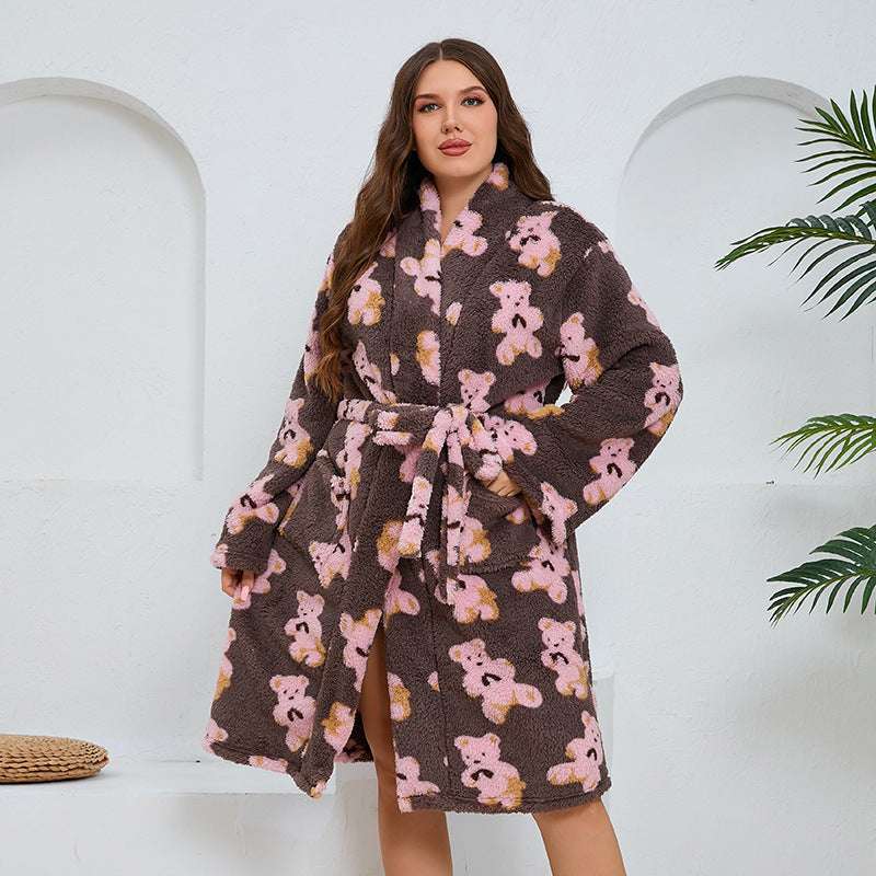 Woman wearing a brown robe with teddy bear pattern on a white background
