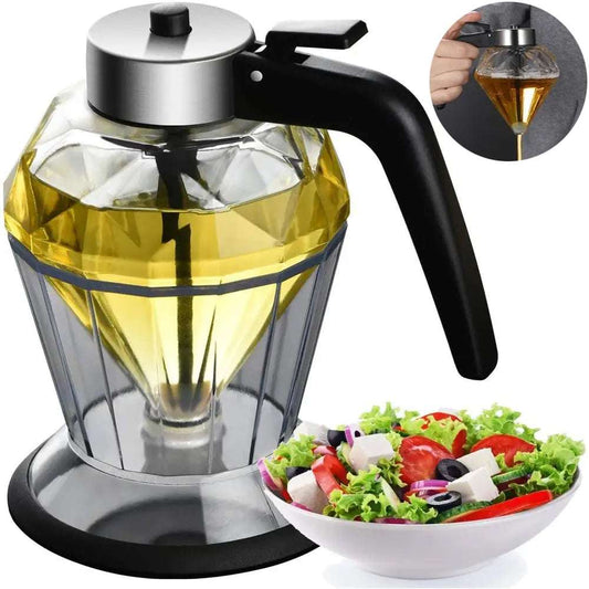 Glass oil dispenser with black handle next to a bowl of salad on a white background