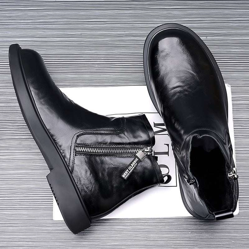 Black leather boots with zippers on a white background