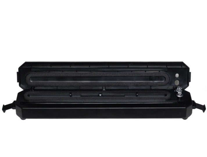 Black vacuum sealer unit with open sealing chamber and side handles