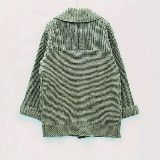 Green knitted cardigan on a light pink background
