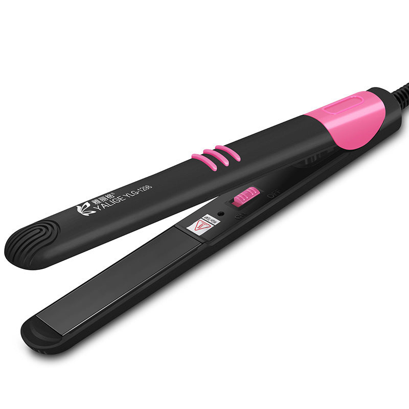 Black and pink hair straightener on a white background