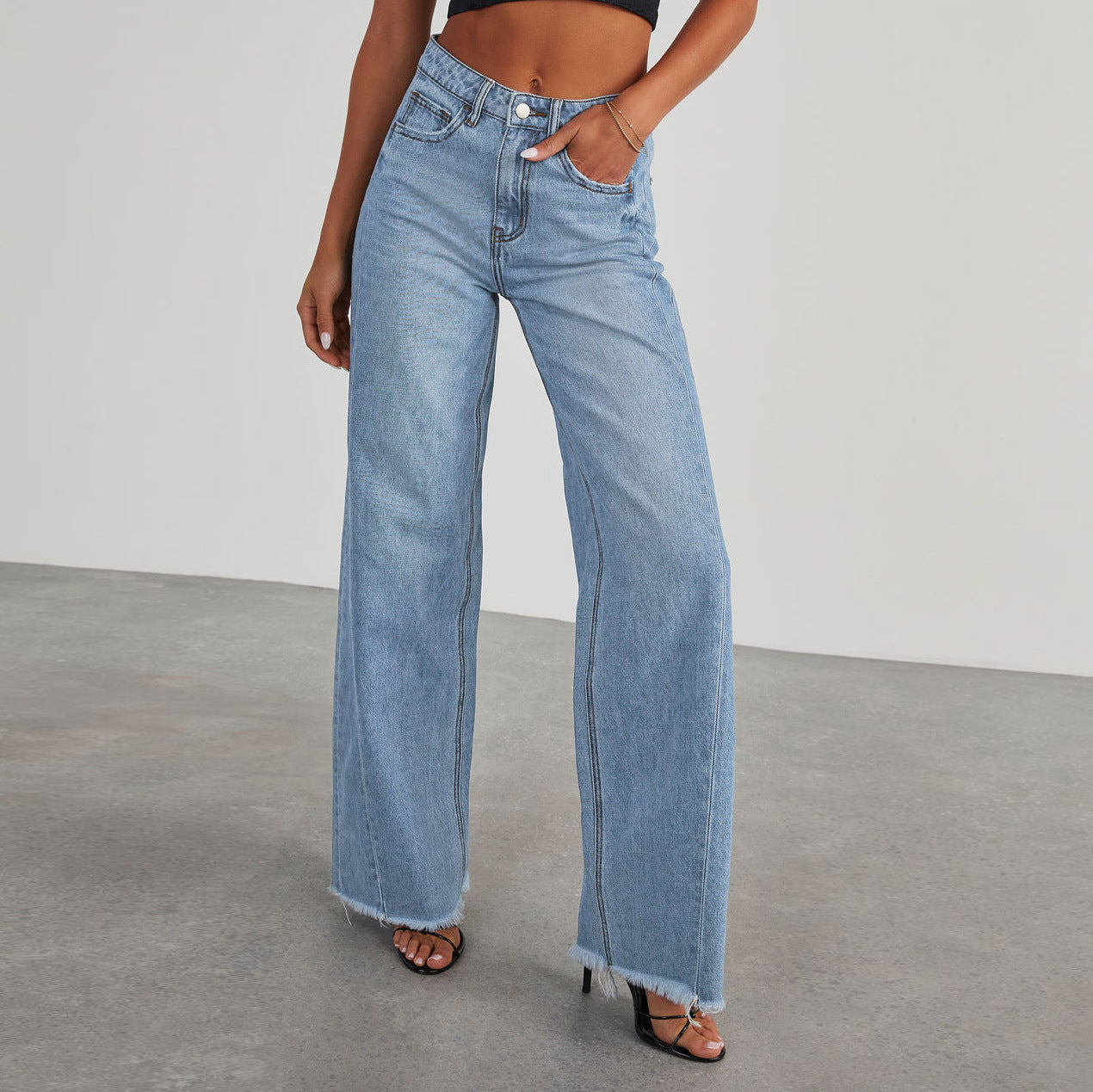 A collage of four images showing high-waisted straight-leg jeans in various colors including blue, light blue, grey, and black, with a model wearing the jeans.