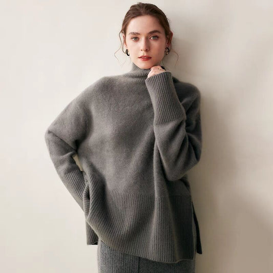 Woman wearing a gray sweater against a plain background