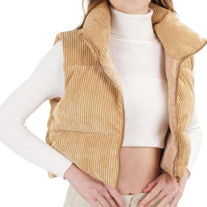 Beige corduroy vest worn over a white long-sleeve shirt on a white background