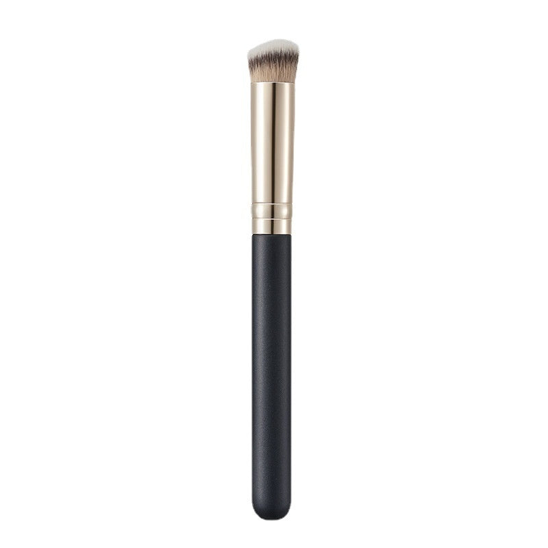 Makeup brush with black handle and gold ferrule on a white background