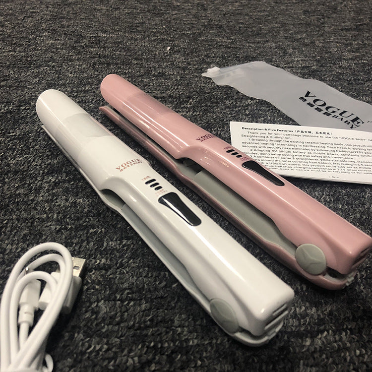 Two hair straighteners, one white and one pink, on a textured surface with a Vogue magazine in the background.