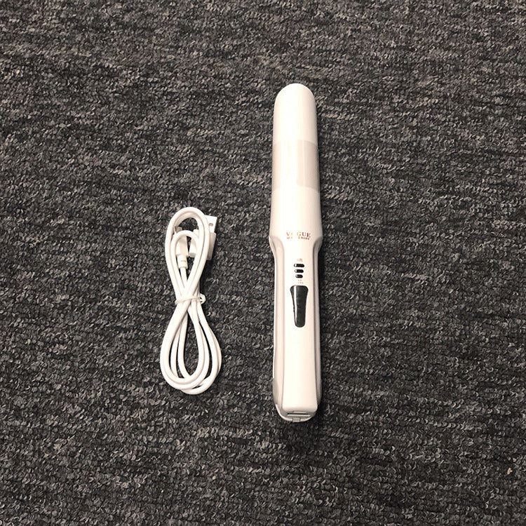 White hair straightener with cord on a dark textured surface