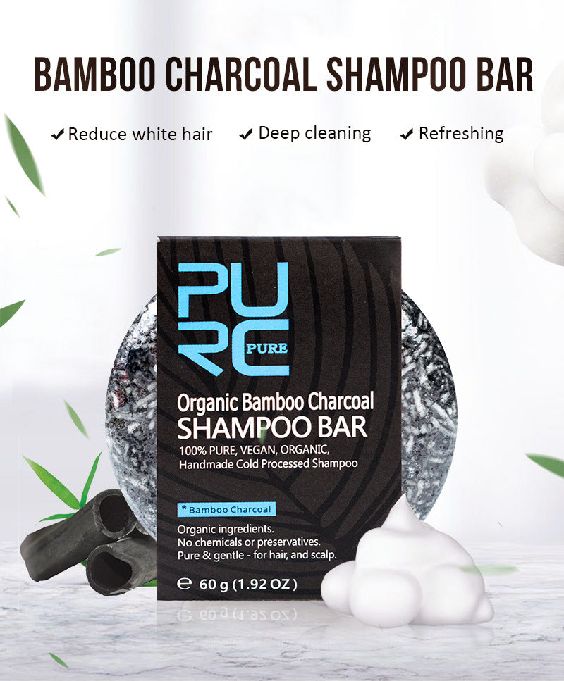PURC Organic Bamboo Charcoal Shampoo Bar packaging with bamboo leaves and shampoo foam on a light background
