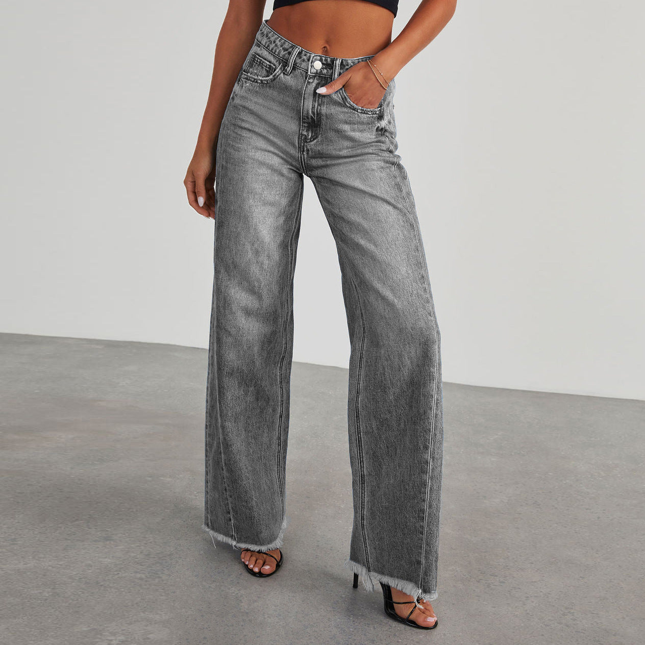 A collage of four images showing high-waisted straight-leg jeans in various colors including blue, light blue, grey, and black, with a model wearing the jeans.