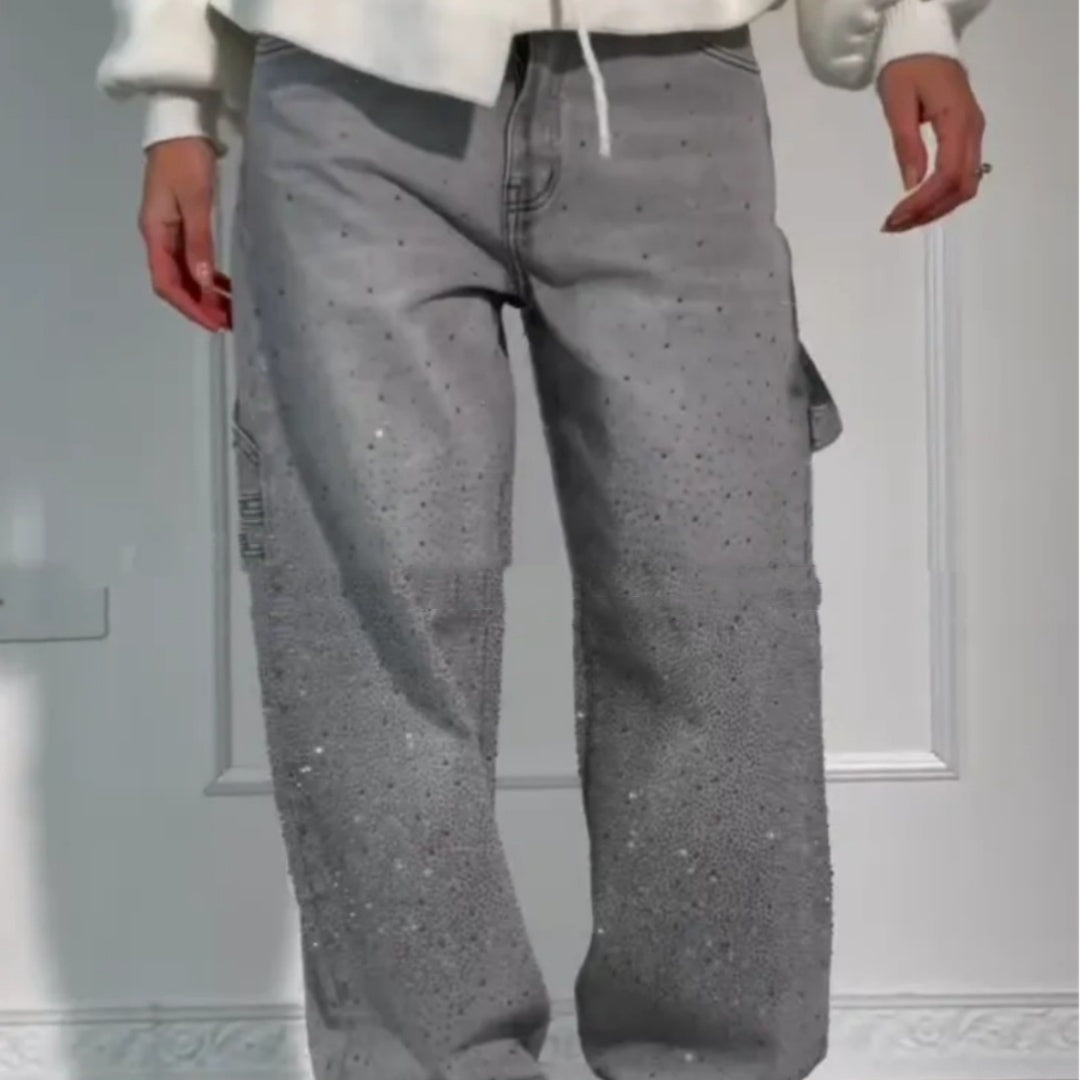Person wearing gray pants with a subtle pattern against a neutral background