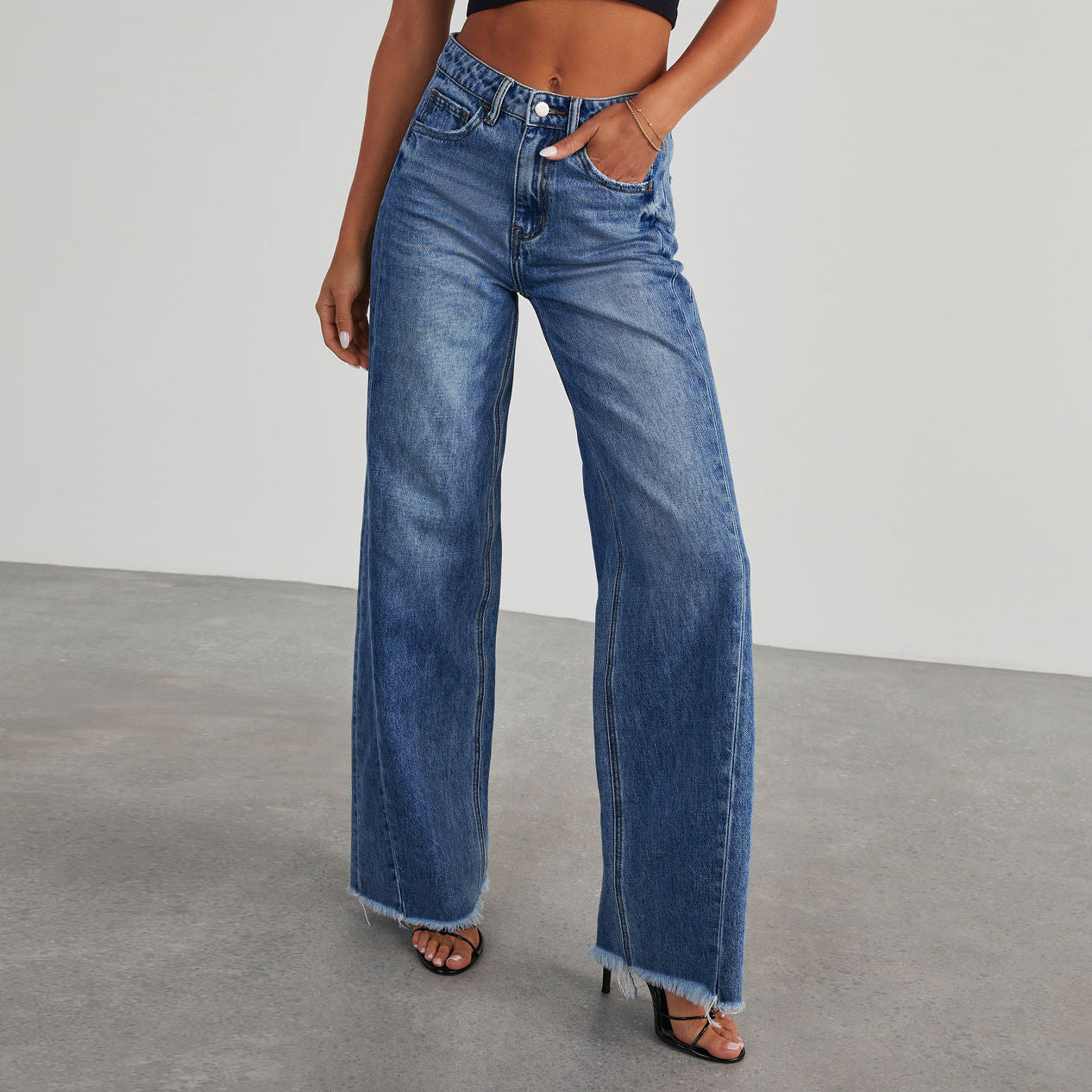 A collage of four images showing high-waisted straight-leg jeans in various colors including blue, light blue, grey, and black, with a model wearing the jeans.