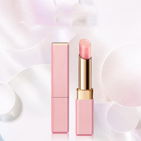 Pink lipstick with gold accents on a light abstract background