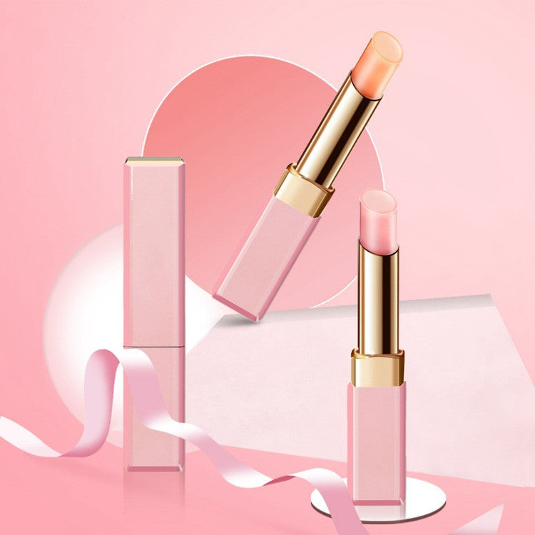Pink lipstick with gold accents on a pink background