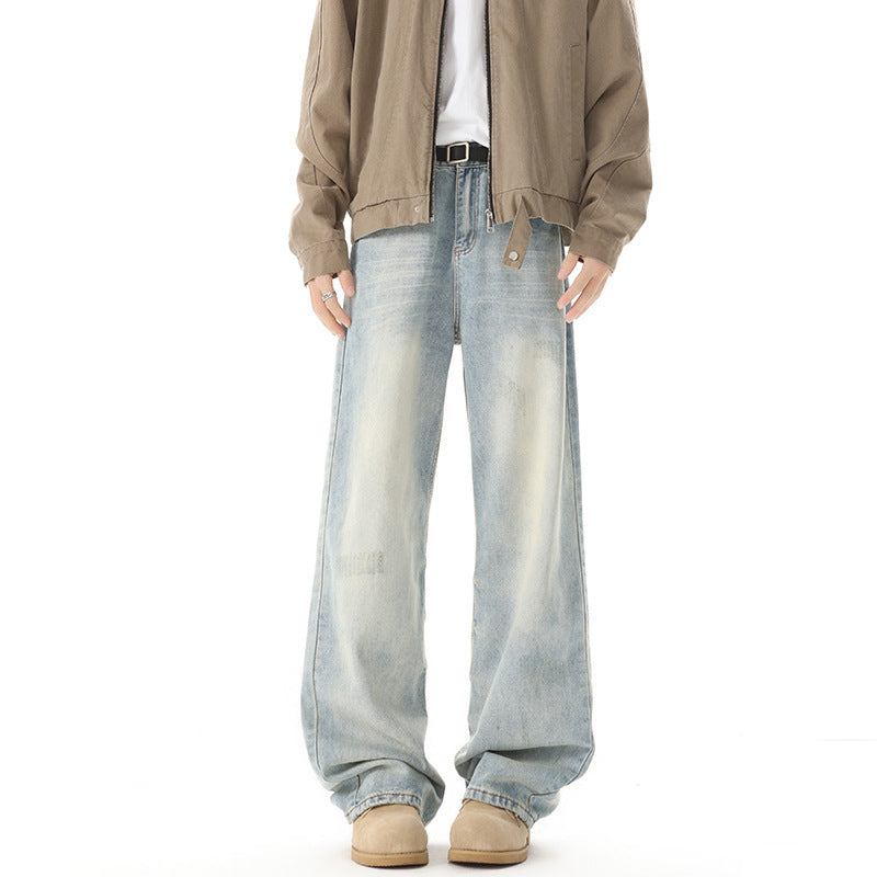 Person wearing light blue jeans and a beige jacket on a white background