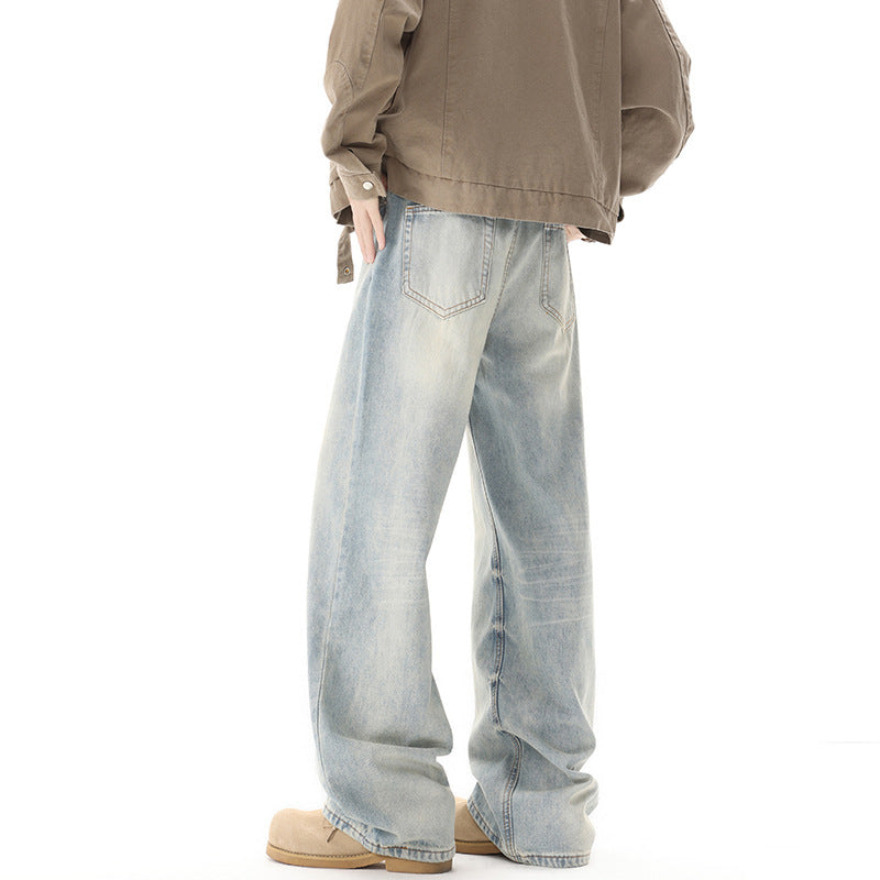 Person wearing light blue jeans and a beige jacket on a white background