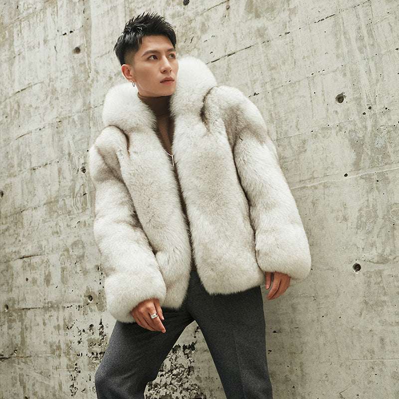 Person wearing a white fur coat against a textured wall