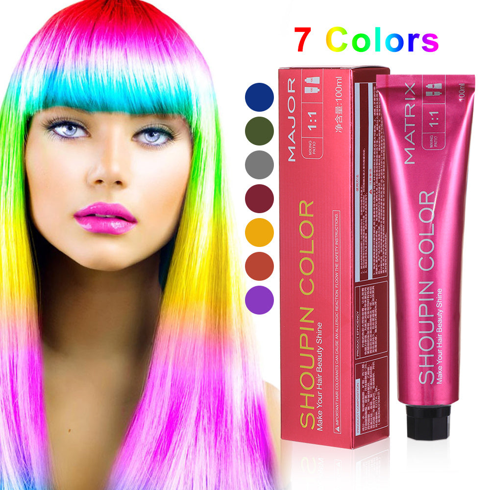 Woman with colorful hair next to Shoupin Color hair dye packaging and color chart.