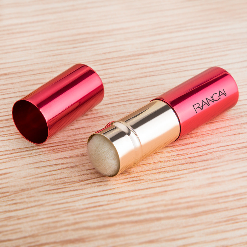 Red lipstick with gold cap on a wooden surface, featuring the brand 'RANCA'.