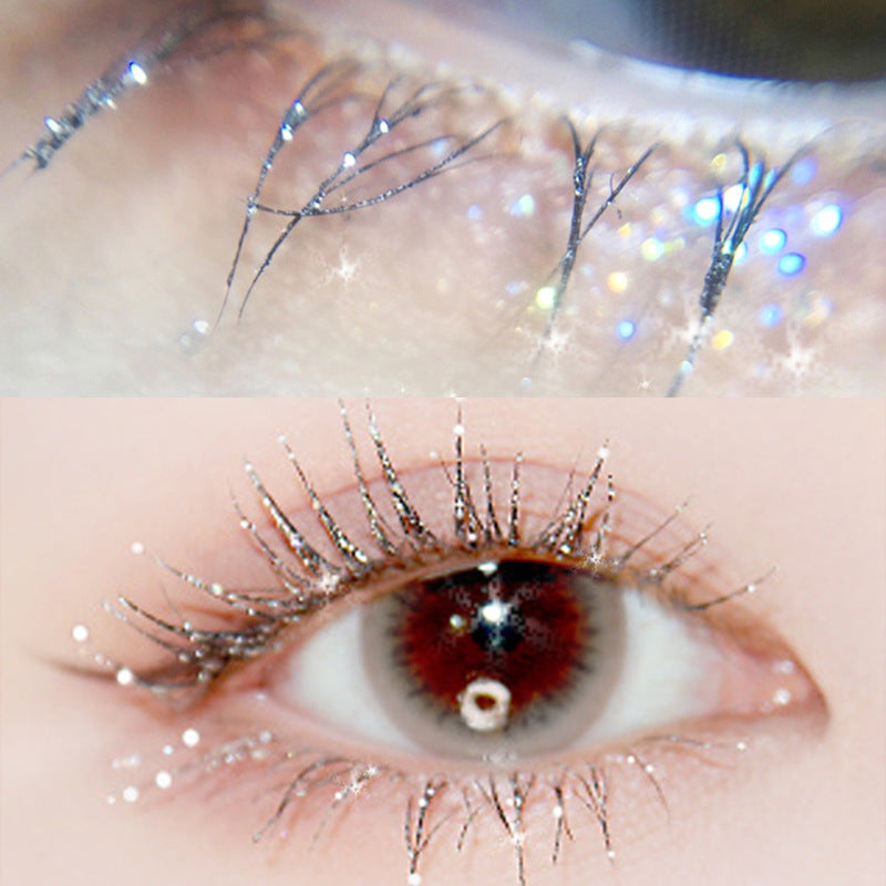 Close-up of a person's eye with decorative false eyelashes and glitter.