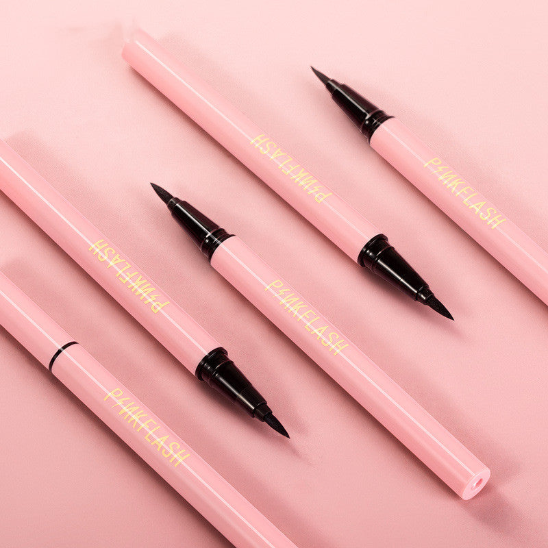 Pink eyeliner pencils with black tips on a pink background
