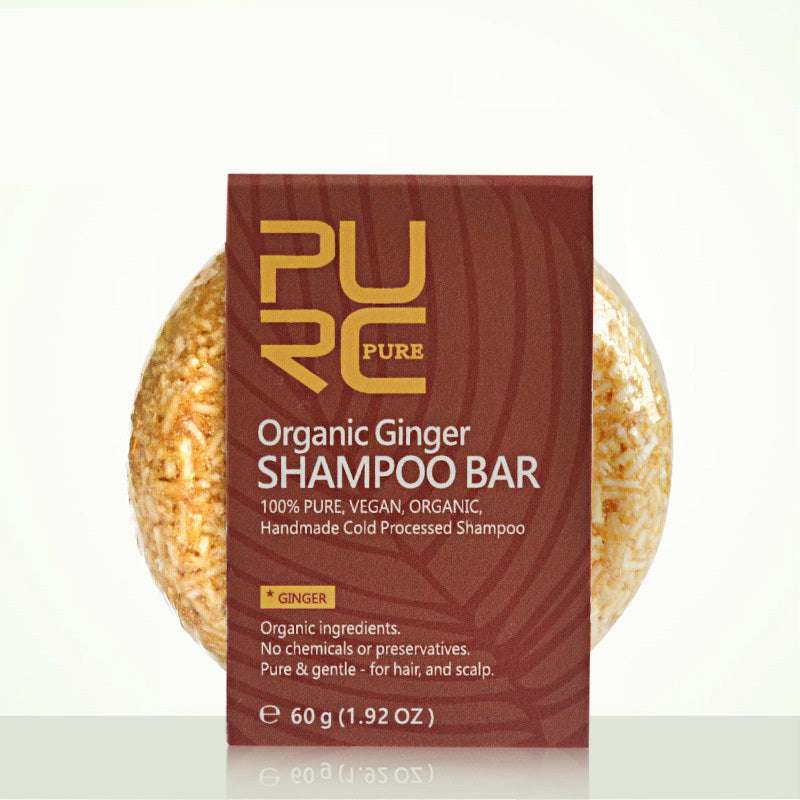 Organic ginger shampoo bar with 'PURE' packaging on a white background