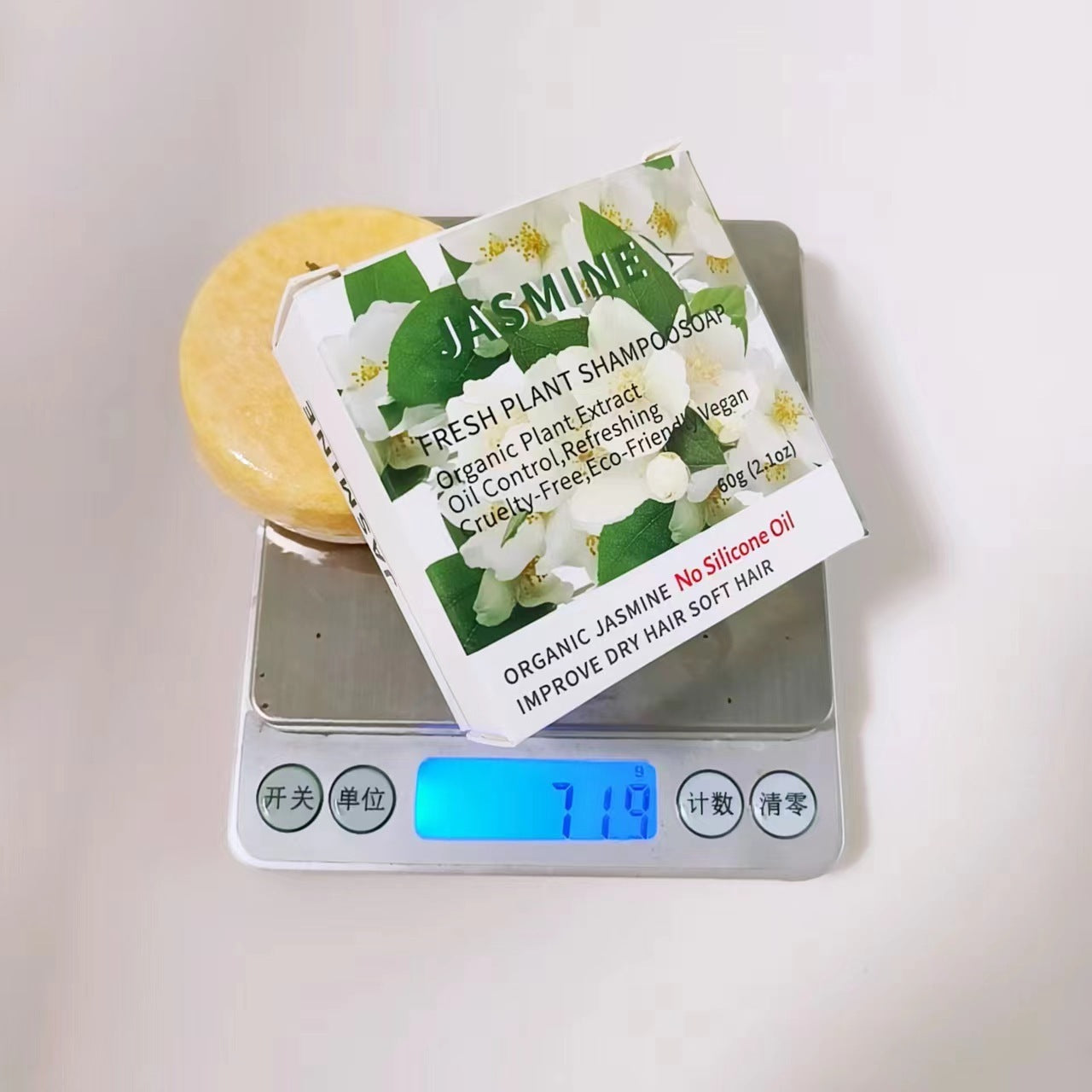 Jasmine shampoo bar on a digital scale with packaging