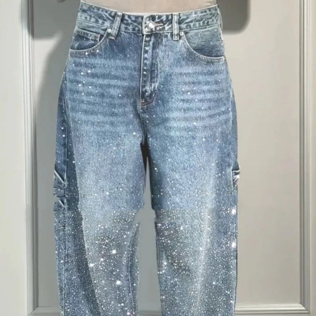Blue jeans with glittery texture on a neutral background