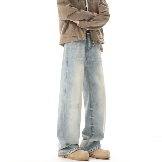 Person wearing light blue jeans and a beige jacket on a white background
