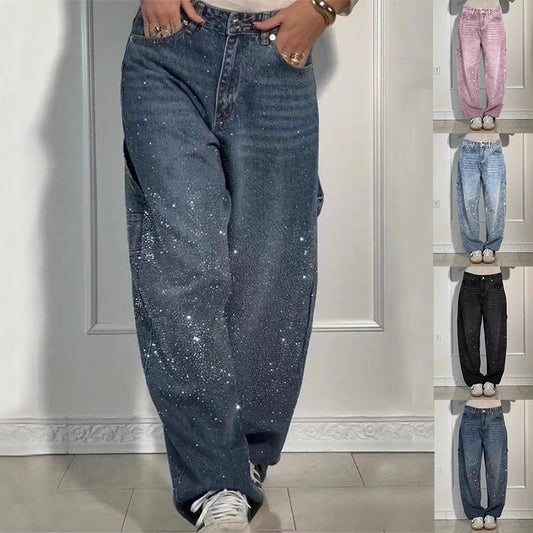 Blue jeans with glittery stars worn by a person, displayed against a neutral background.