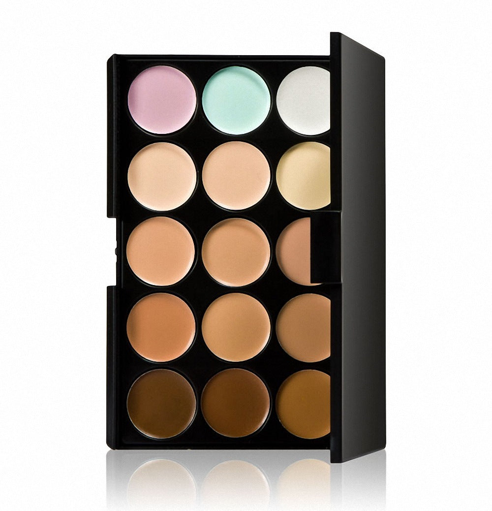 Makeup palette with various shades of cream in a black box on a white background