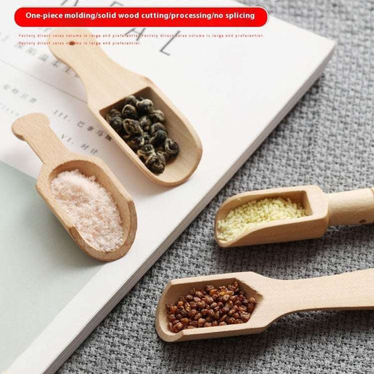 Four wooden measuring spoons filled with different substances on a textured surface.