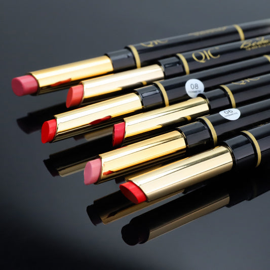 Set of lip pencils with gold and black accents on a dark background