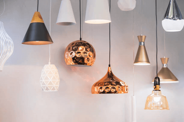 A display of modern chandeliers, floor lamps, and recessed fixtures from the Indoor Lighting Collection