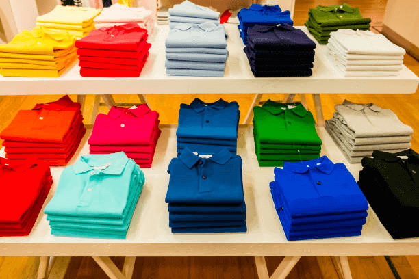 A stack of white, grey, and black basic tees from the Premium Men's T-Shirts collection