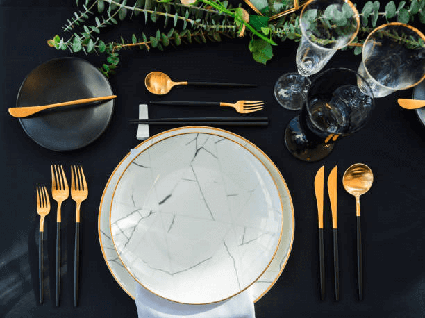 A stack of white porcelain dinner plates and salad plates from the Elegant Plate Sets collection
