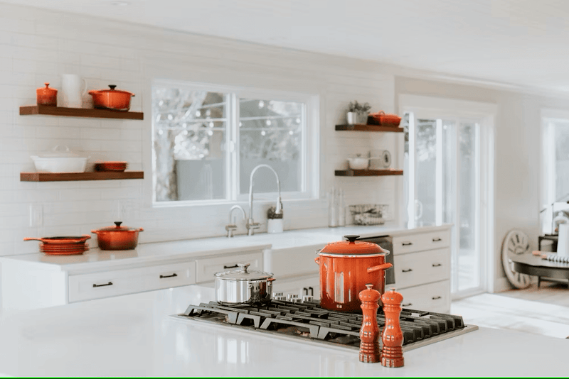A stack of stainless steel pots, nonstick skillets, and cast iron pans from the High-Quality Cooking Pots and Pans collection