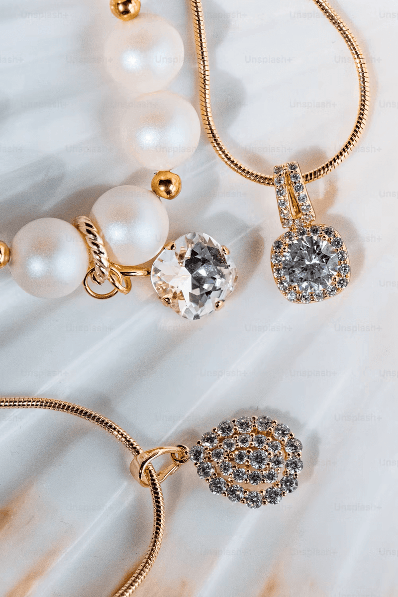 A display of diamond rings, gold necklaces, and colored gemstone pieces from the Exquisite Fine Jewelry Collection