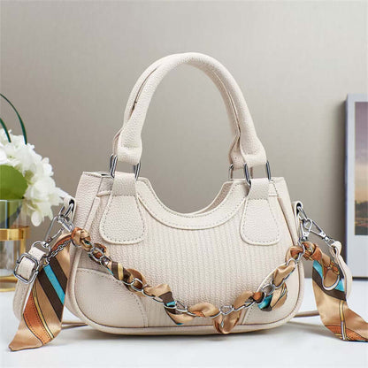 White textured handbag with braided chain strap, dual top handles, and front flap pockets