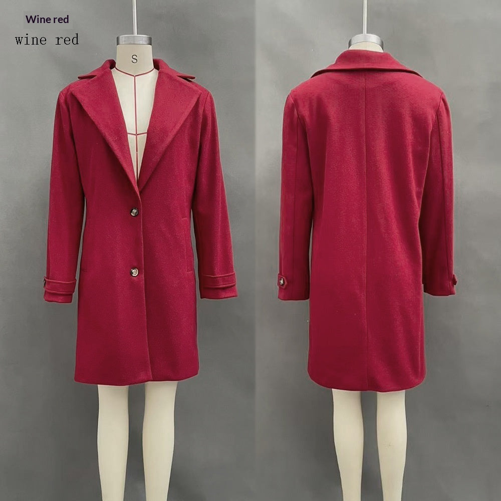 Wine red mid-length lapel coat on mannequin with button front and long sleeves