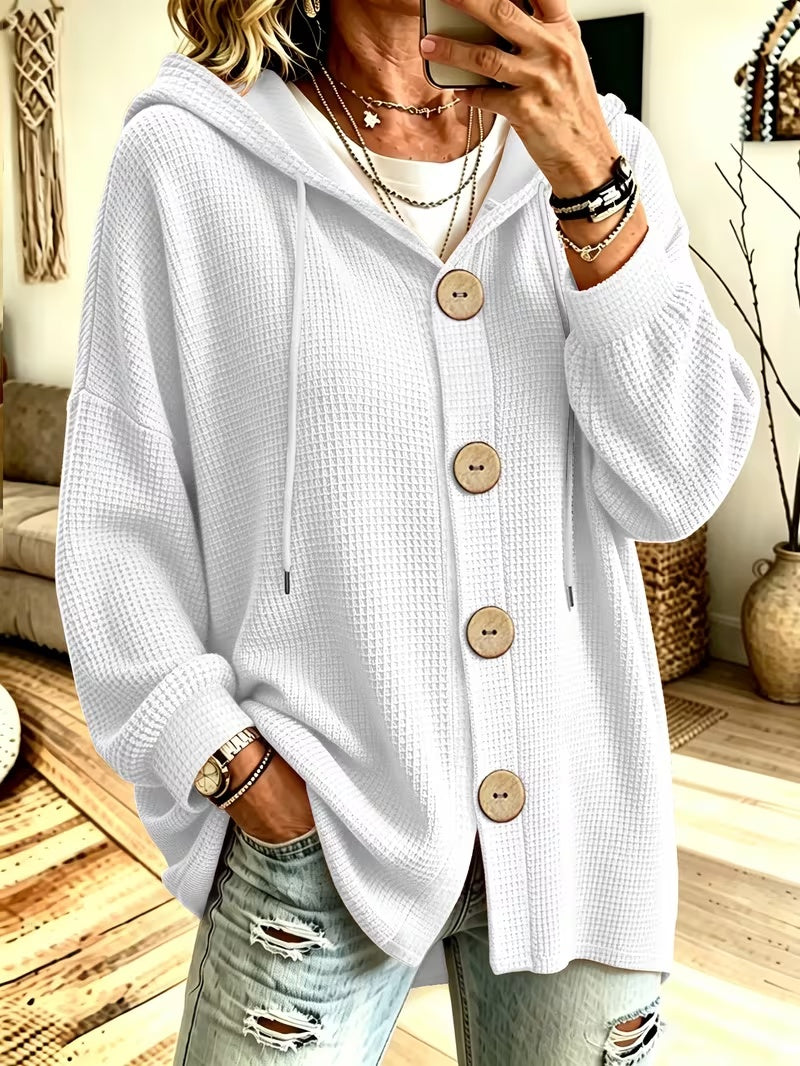 Hooded knit blouse in white with long sleeves, button placket, and drawstring ties